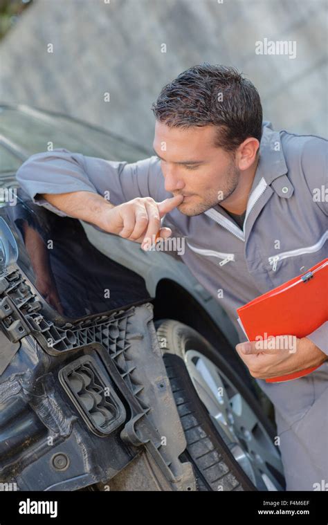 Mechanic Assessing Car Stock Photo Alamy