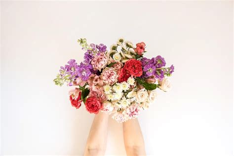 premium photo flowers bouquet  female hands  white background