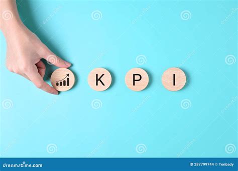 Key Performance Indicator Businessman Holding Wooden Cube With KPI