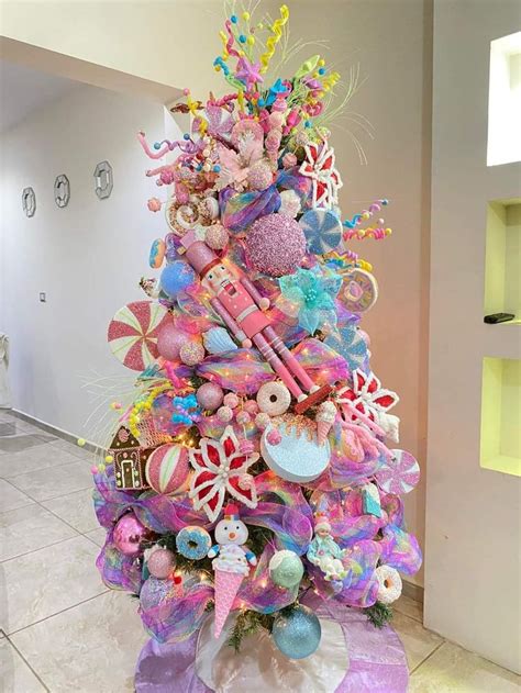 A Brightly Colored Christmas Tree With Lots Of Decorations On It S Top