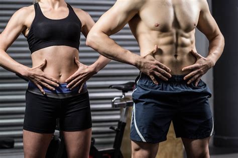 Premium Photo Midsection Of Fit Couple Posing At Crossfit Gym