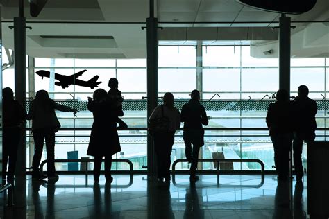 Silhouette Of Group Of People Standing Inside An Airport Hd Wallpaper Wallpaper Flare