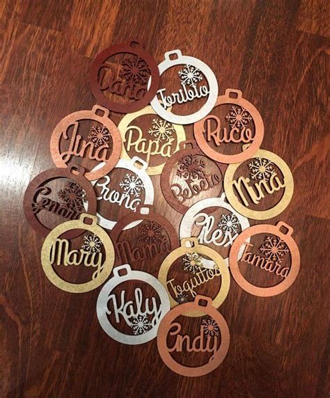 Twelve Personalized Christmas Ornaments On A Wooden Table