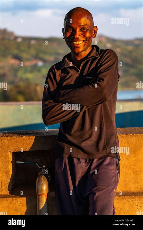 Portrait Of A Smiling Rwandan Man In The Late Afternoon Light Kinunu