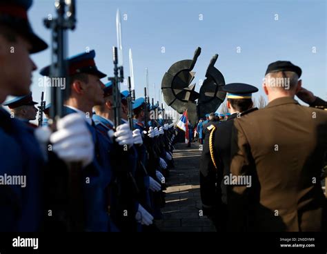 A Serbian Military Honor Guard Left And Foreign Military Attaches Pay