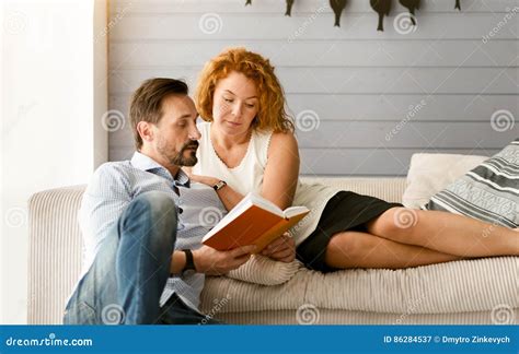 Lovely Couple Reading Book Together At Home Stock Image Image Of