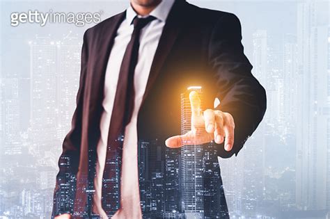 Man Pointing Finger At Virtual Screen With Modern City Skyline Real