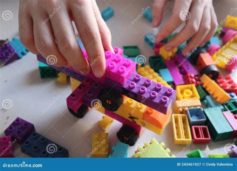 Building And Playing Lego On Top Of Scattered Legos On The Floor Stock