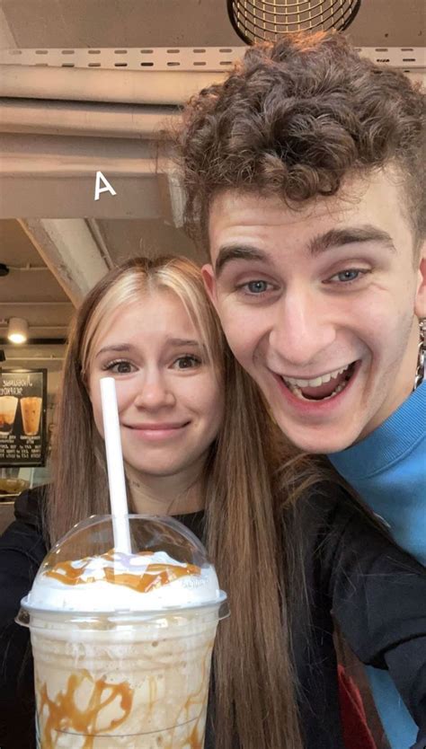 two people are smiling and drinking milkshakes in front of the camera ...