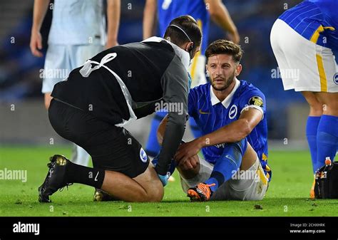 Brighton and Hove Albion's Adam Lallana receives treatment for an injury before being ...