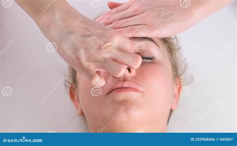 Facial Massage Beauty Treatment Close Up Of A Young Womans Face Lying