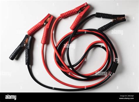 Black and red jumper cable isolated on white background Stock Photo - Alamy