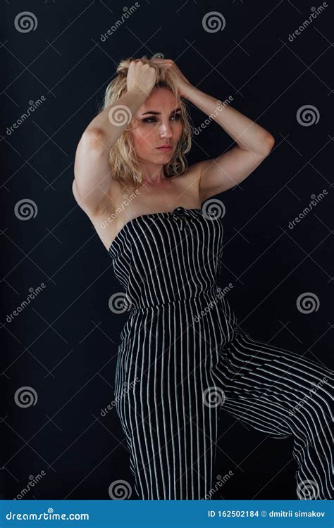 Portrait Of A Beautiful Fashionable Blonde Woman In Striped Clothes