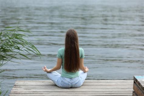 Premium Photo Teenage Girl Meditating Near River Back View