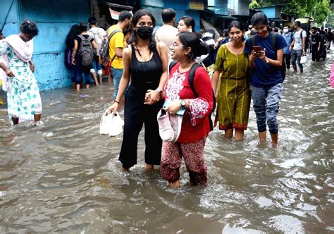 Kolkata People Wade Through Waterlogged Street After Heavy Rainfall