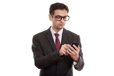 Premium Photo Young Businessman Wearing Eyeglasses While Using Smartphone