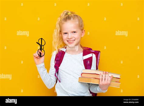 Back to school. Portrait of blonde school girl in round glasses with