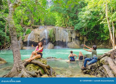 Deep Forest Waterfall With Tourist In Erawan National Park Kanchanaburi