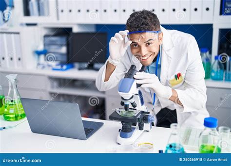 African American Man Scientist Using Microscope Working At Laboratory