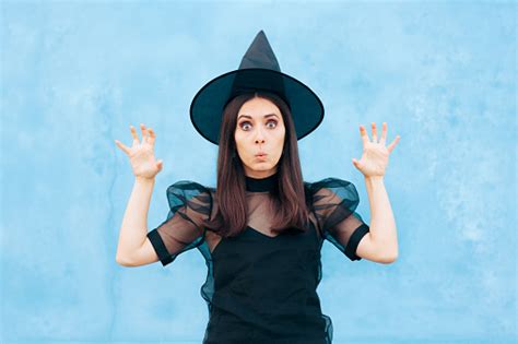 Funny Woman Wearing Witch Costume Trying To Look Scary Stock Photo