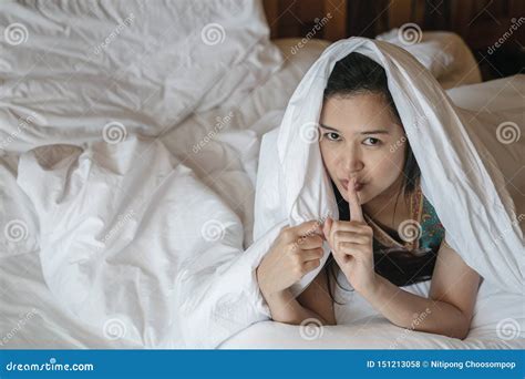 Closeup Asian Woman Lie On Bed Under Blanket And Make A Gesture To Tell