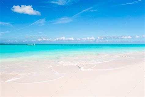 Idyllic Tropical Beach In Caribbean With White Sand Turquoise Ocean Water And Blue Sky