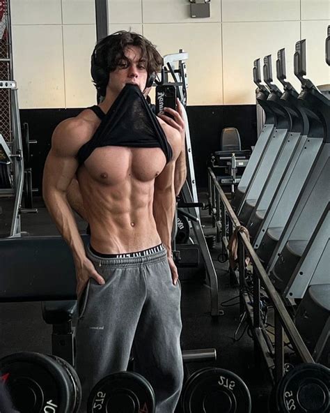 A Shirtless Man Taking A Selfie In The Gym