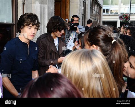 Liam Payne Left And Harry Styles Of One Direction Meet Fans Outside