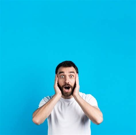 Premium Photo Amazed Man Holding His Head With Hands Write On