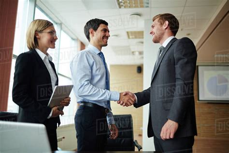 Two Happy Men Greeting One Another After Making Business Agreement