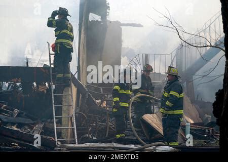 Firefighters Work On Extinguishing Hotspots From A Fire That Burned