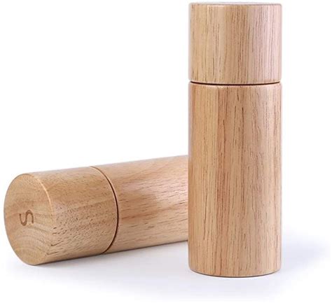 A Wooden Pepper Mill Is Shown On A White Background