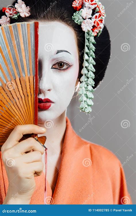 Woman In Geisha Makeup And A Traditional Japanese Kimono Studio