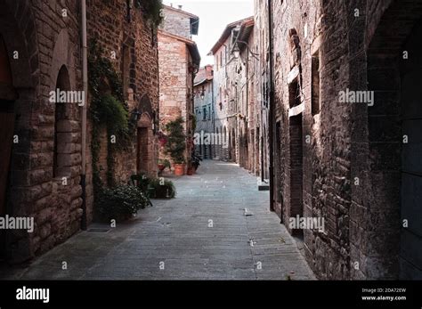 An Alley Of A Medieval Italian Village With Stone Houses Wooden Doors