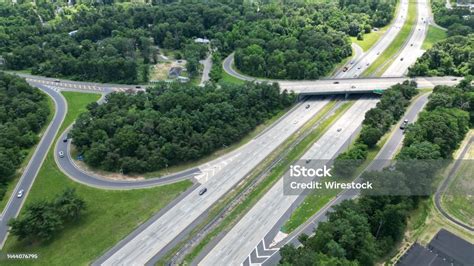 Aerial View Of Cars Passing Through Multilevel Freeways In A Suburban