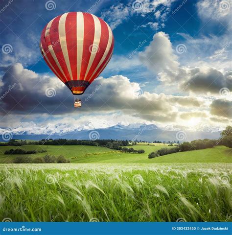 Hot Air Balloon Soaring Over A Picturesque Landscape At Early Morning