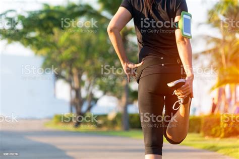 Healthy Life Asian Fitness Woman Runner Stretching Legs Before Run