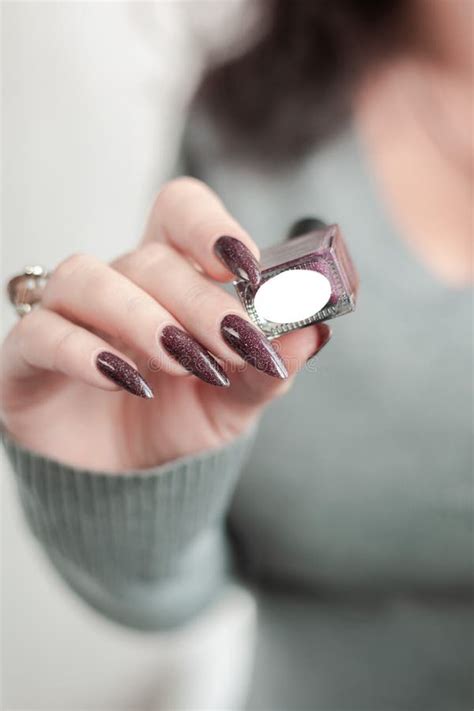 Hand With Long Artificial French Manicured Nails And Lily Flower Stock