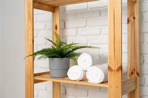 Premium Photo Rolled Fluffy Towels On Shelf In Bathroom