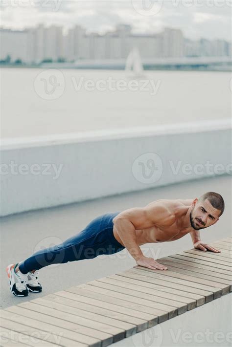 Flexible Fit Man Does Plank Exercise On Promenade Has Naked Torso