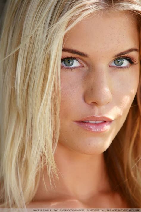 A Beautiful Blond Woman With Blue Eyes And Long Hair