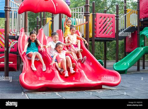 Happy Children Playing On Slide Stock Photo Alamy