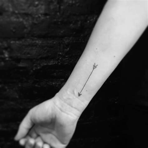 Minimalistic Style Arrow Tattoo Located On The Wrist