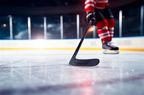 Free Photo Close Up Of Ice Hockey Stick On Ice Rink In Position To Hit Hockey Puck