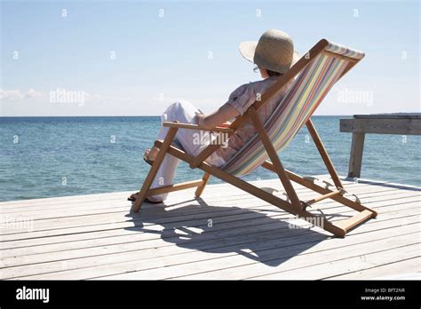 Woman Sitting On Deck Chair Stock Photo Alamy