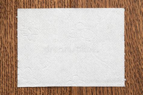 One Sheet Of Toilet Paper Lies On A Wooden Surface Stock Photo Image