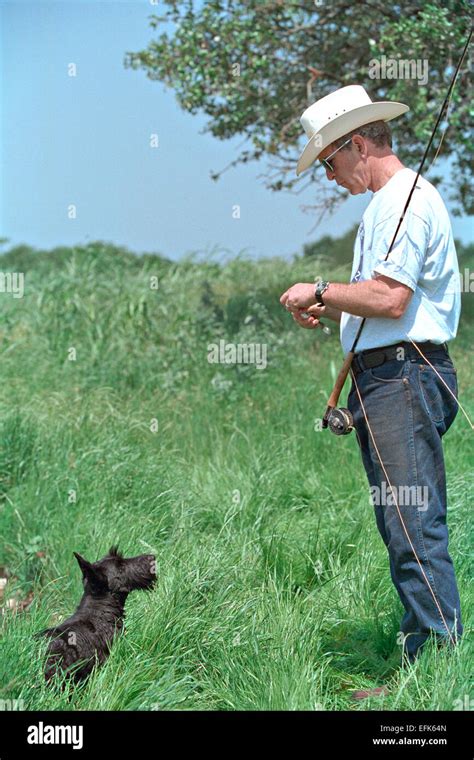 Us President George W Bush Wearing A Cowboy Hat With His Dog Barney As