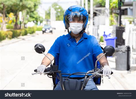 Delivery Man Wearing Blue Uniform Riding Stock Photo 1828334789 ...