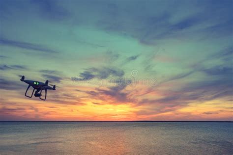 Silhouette of Drone Quad Copter Flying in Sky Stock Photo - Image of ...