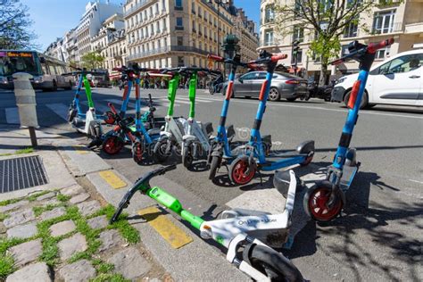 Rental Electric Scooters Parked On The Side Of The Roadway In Paris